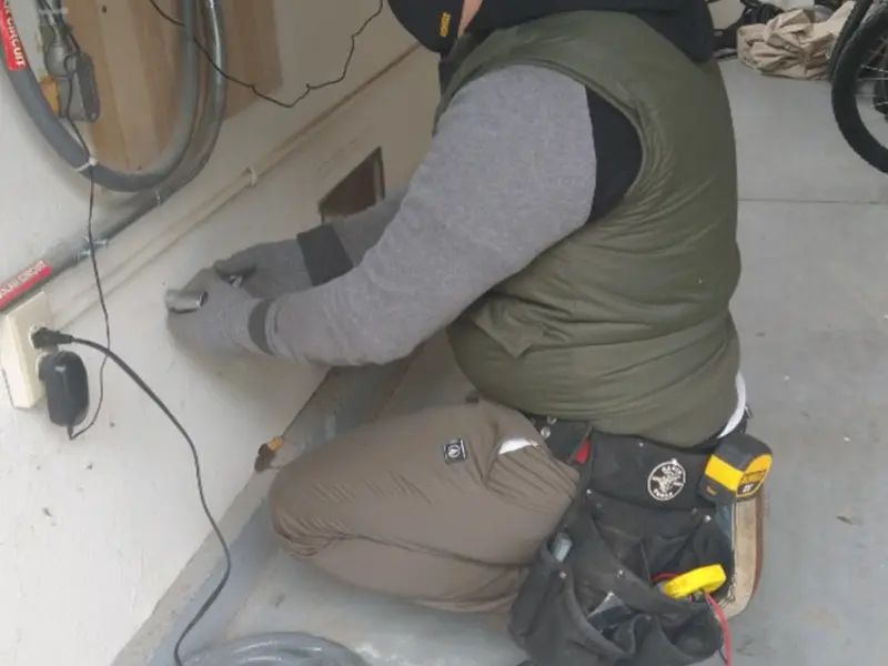 Electrician performing outlet wiring in a Livermore garage